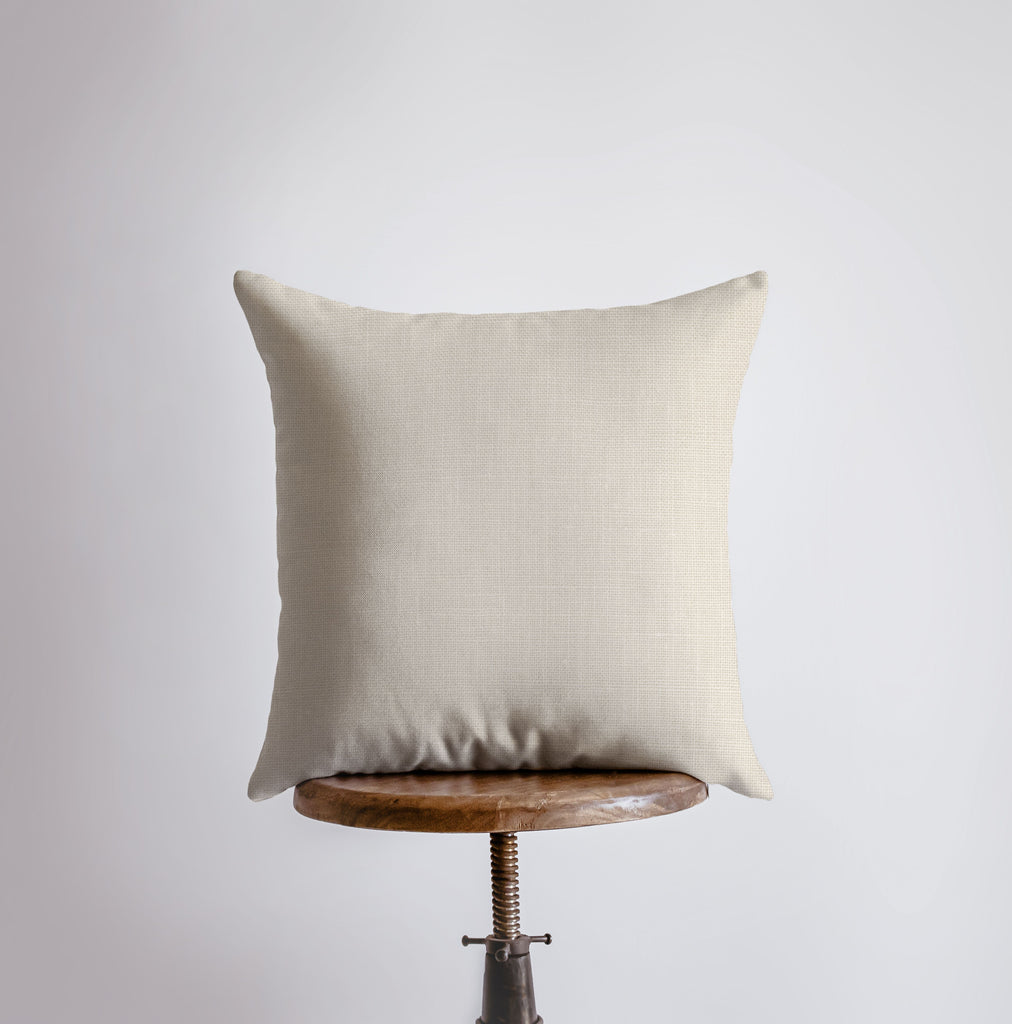 a white pillow sitting on top of a wooden table