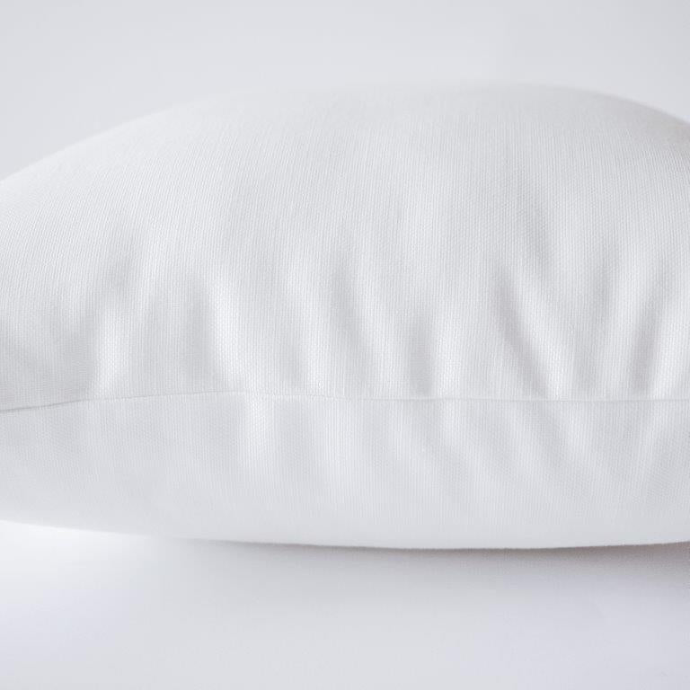 a close up of a white pillow on a white surface