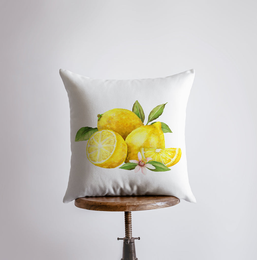 a pillow with lemons and leaves on it