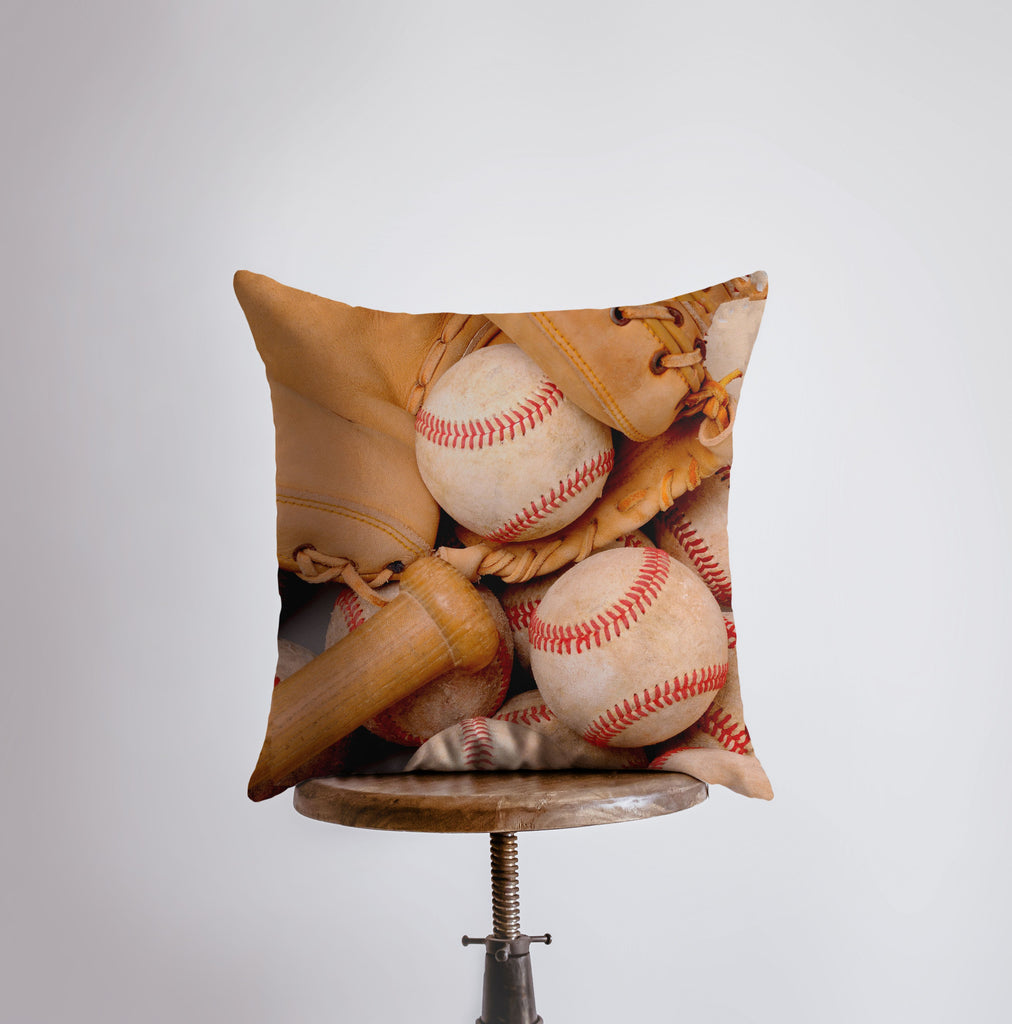 a pillow that has a baseball and a bat on it