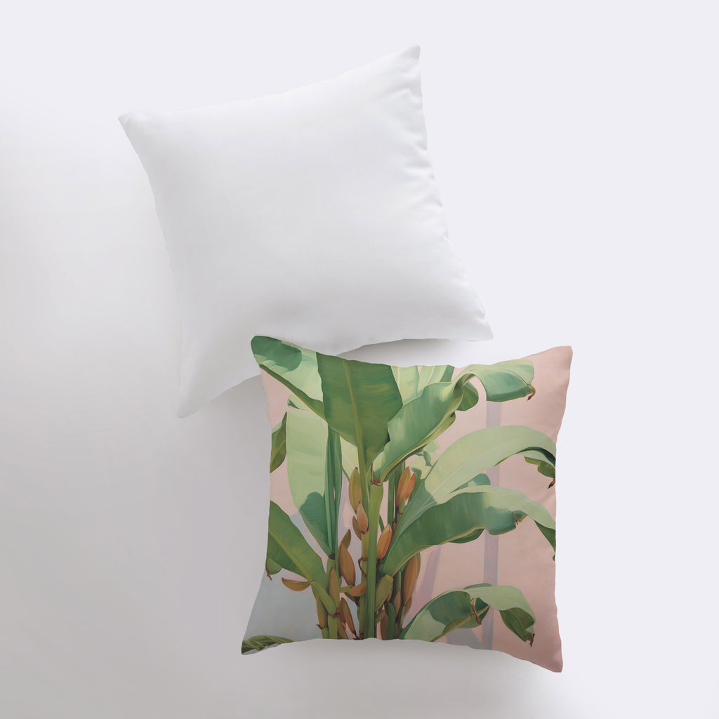 a white pillow with a green plant on it