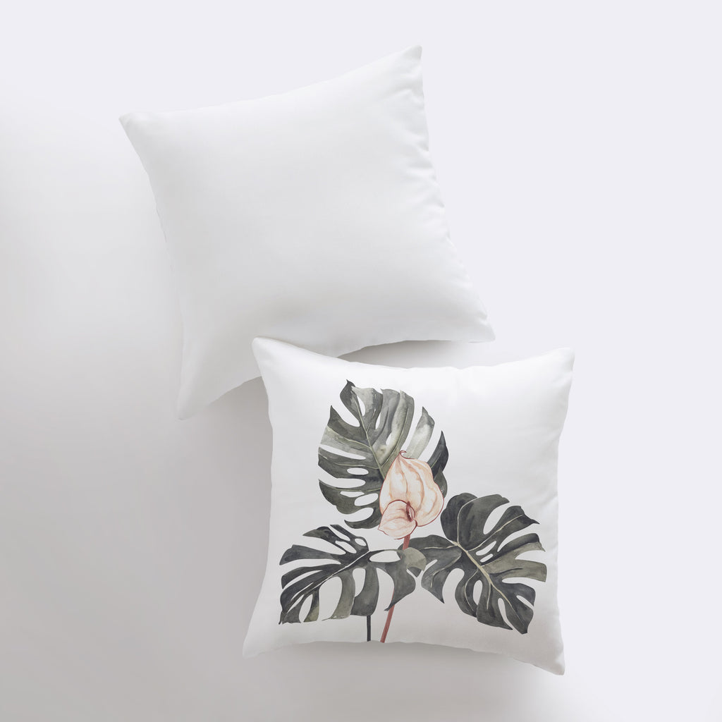 two white pillows with a pink flower on them