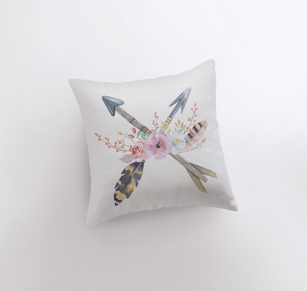 a white pillow with an arrow and flowers on it