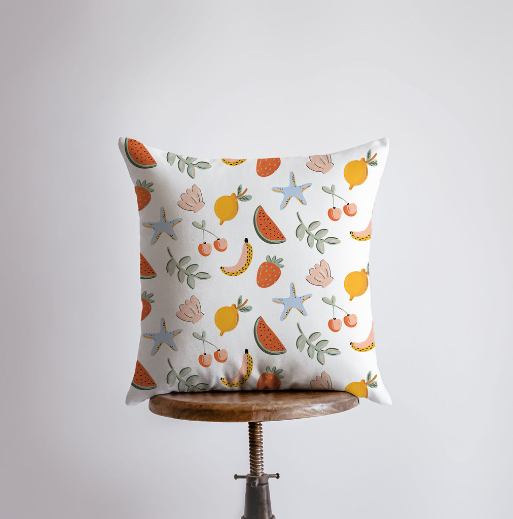 a white pillow with a fruit pattern on it