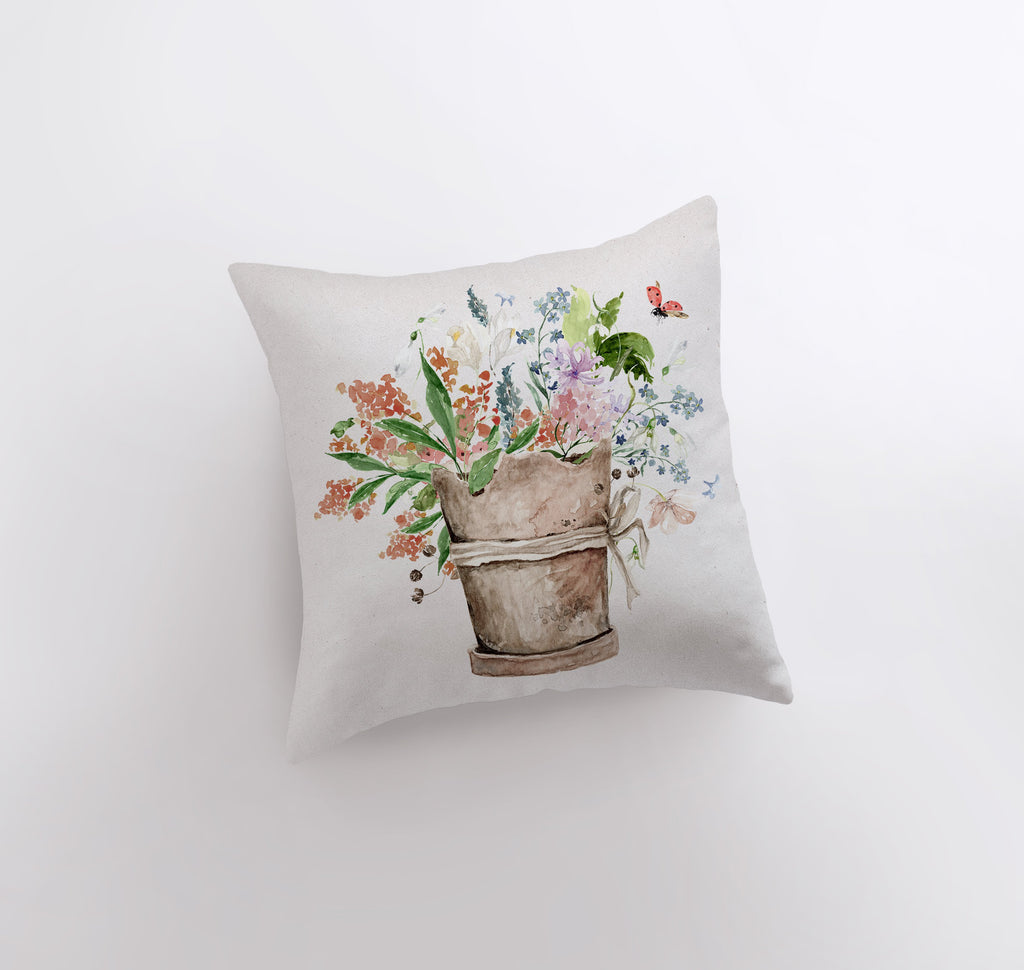 a pillow with a painting of a flower pot on it