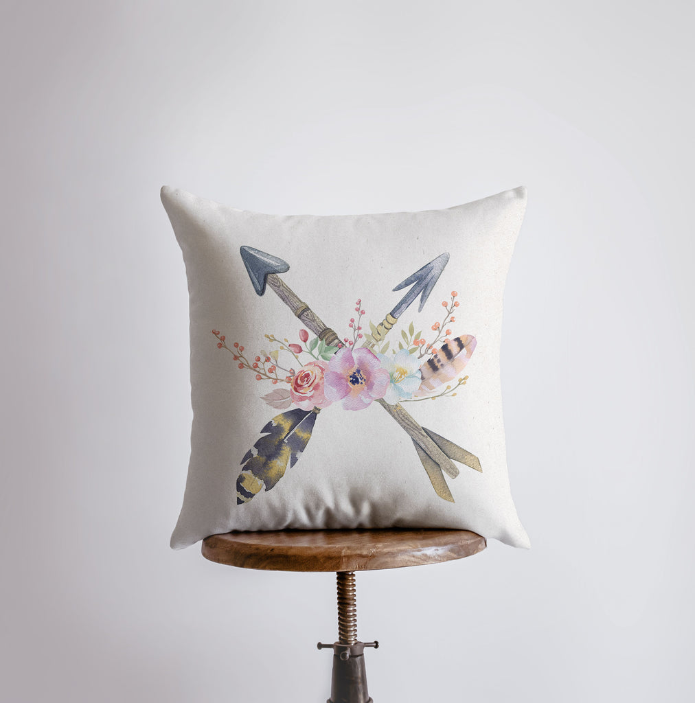 a pillow with arrows and flowers on it