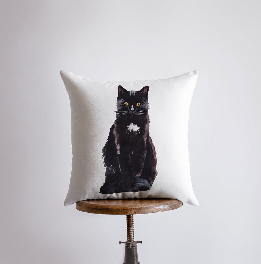 a pillow with a picture of a black cat on it