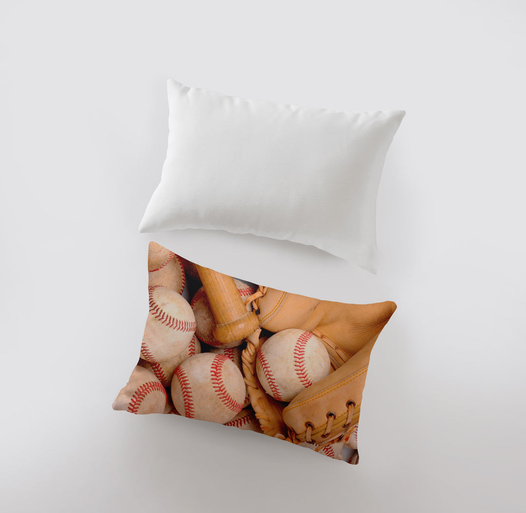 a pillow with baseballs and gloves on it