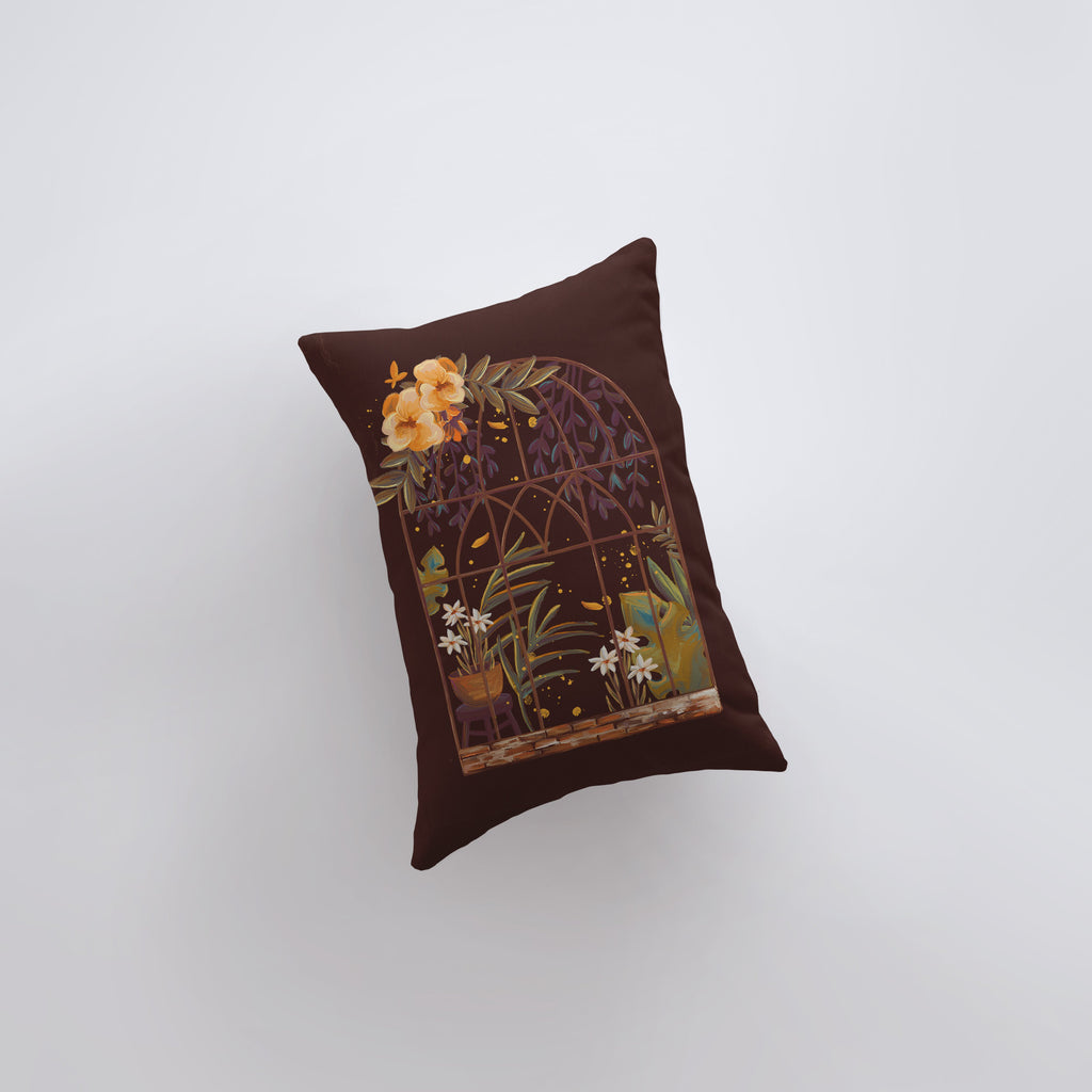 a brown pillow with a picture of a bird in a cage