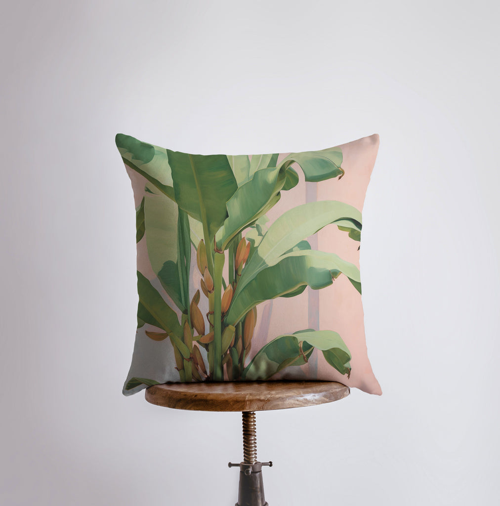 a pillow with a plant on it sitting on a table