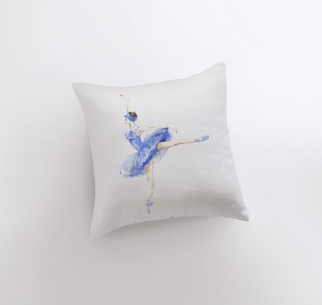 a white pillow with a blue ballerina on it