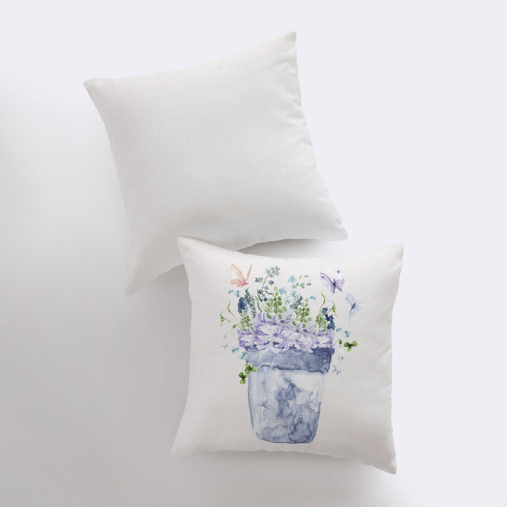 two pillows with flowers in a vase on them