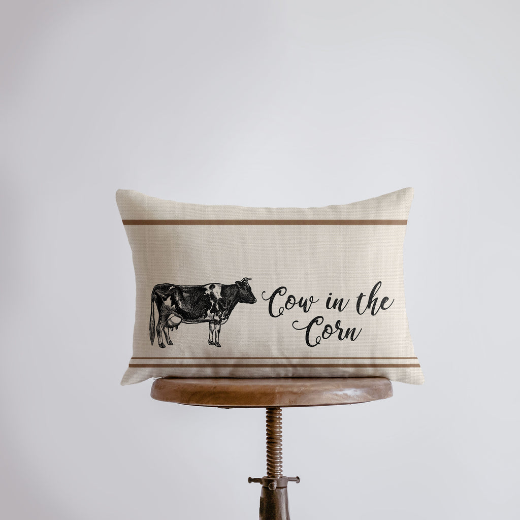 a pillow with a cow on it that says cows in the corn