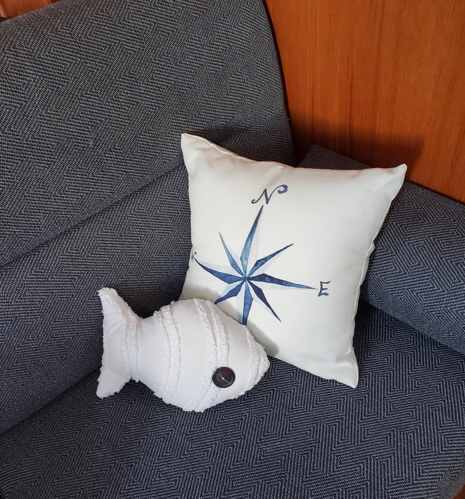 Watercolor compass pillow arranged on a sailboat seat